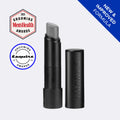 A black cosmetic tube and its matching cap on a light gray background, with a silver-gray product bullet visible. The cap is embossed with the brand name HARRY'S.