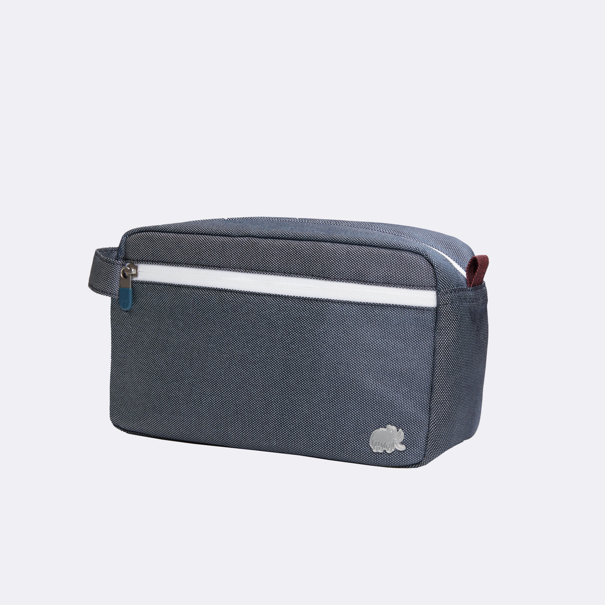 Blue toiletry bag with a white stripe on a light gray background