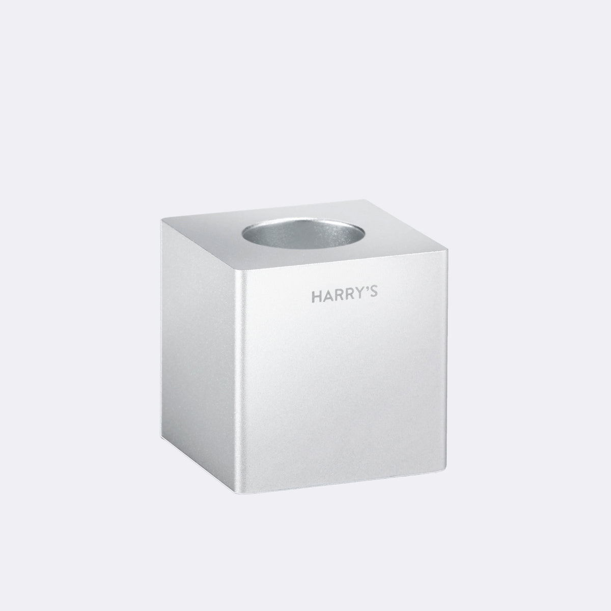 Harry's razor stand, a block of steel with a hole in the top to hold razors.
