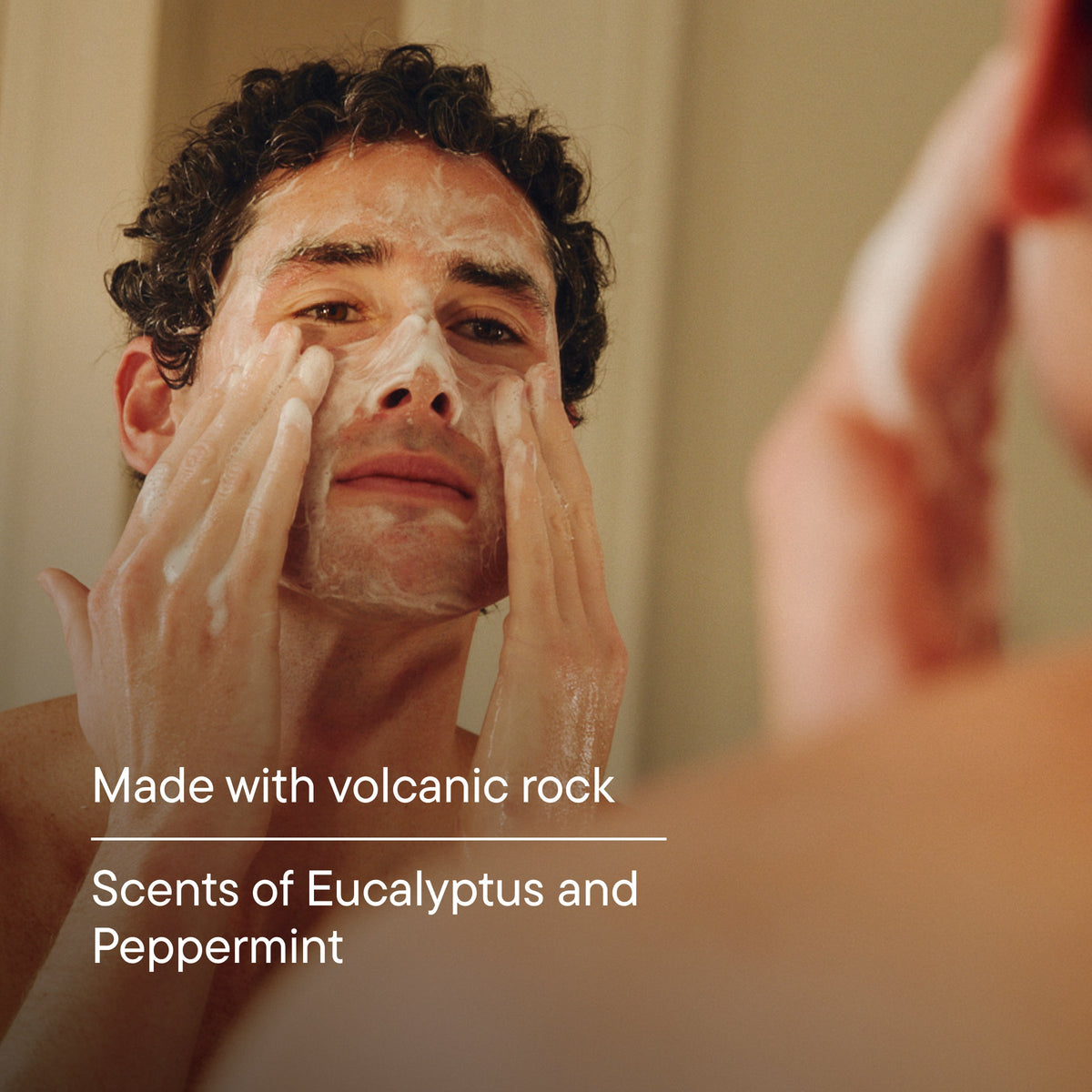 Man applying cream to his face with a blurred background