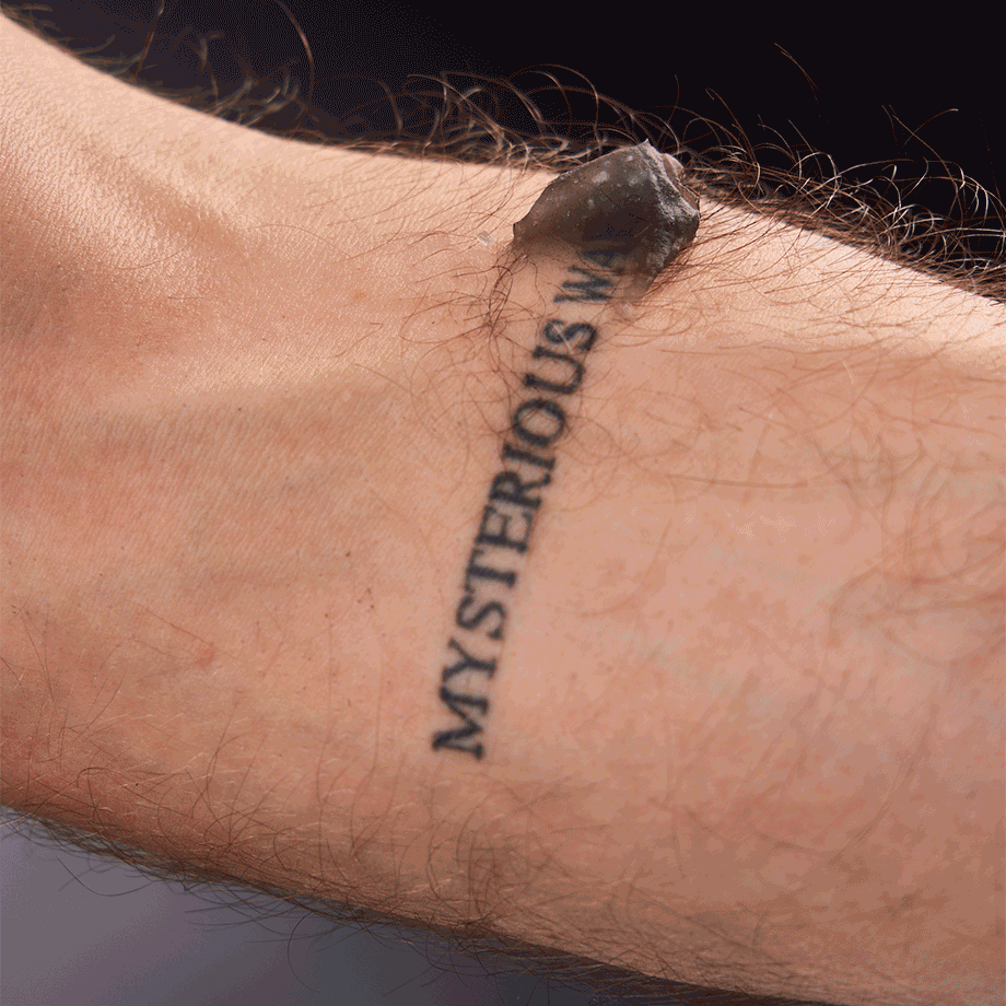 Gif of person applying the product on their small text tattoo.