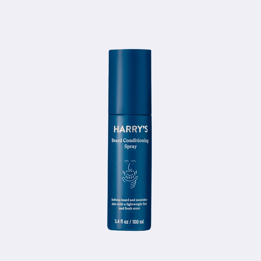Blue bottle of Harry's beard conditioning spray on a light blue background