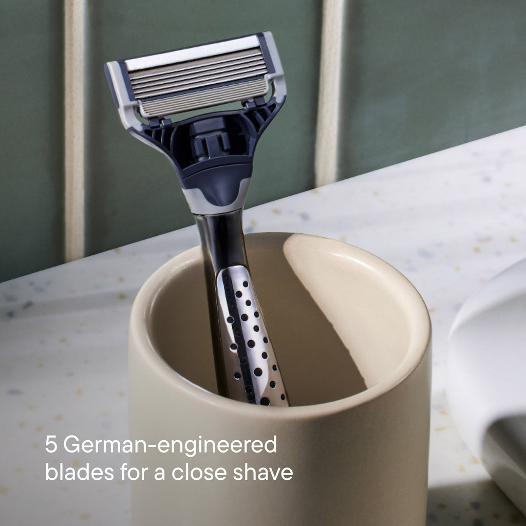 Craft  razor in a beige cup with text about German-engineered blades  in a ceramic cup.