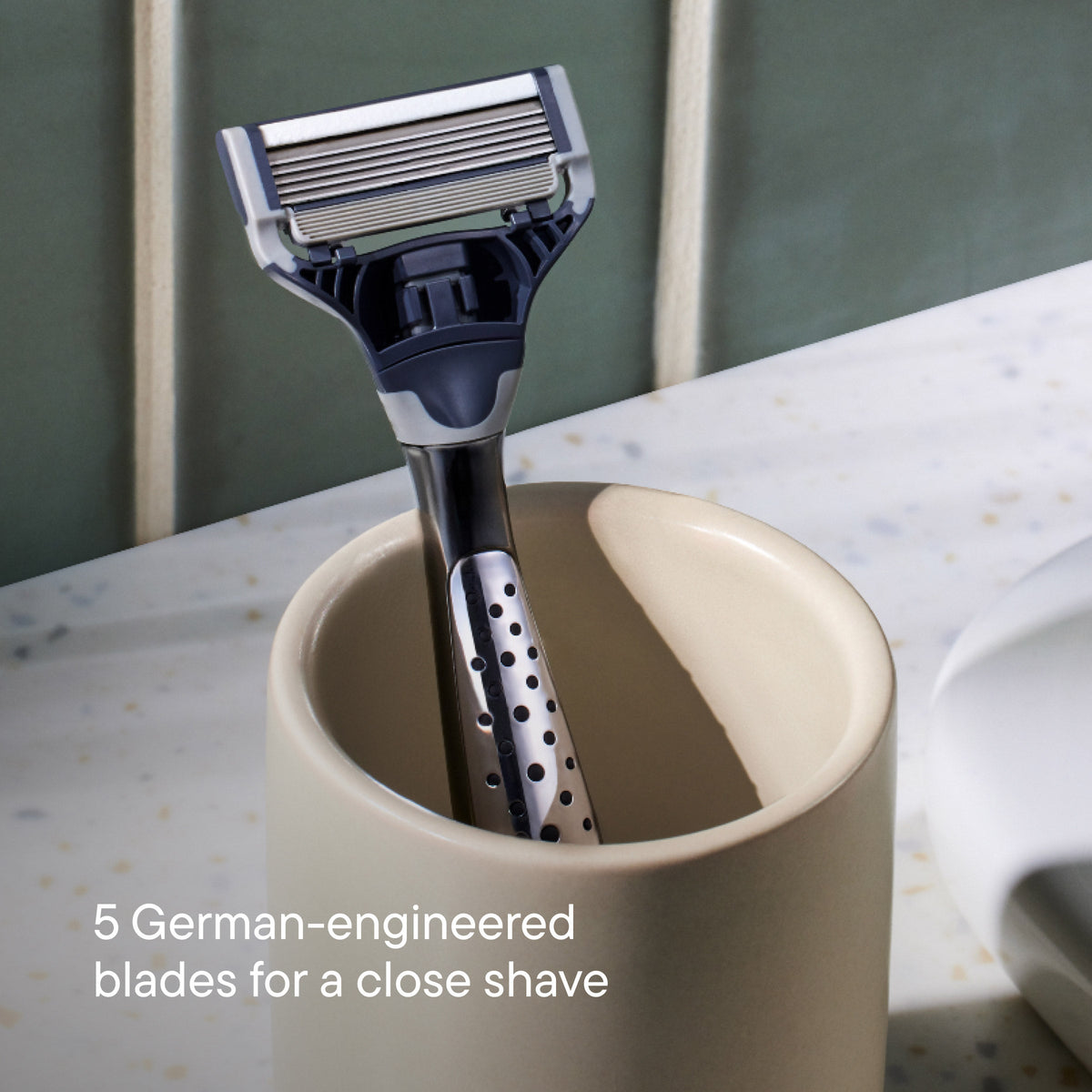 Craft  razor in a beige cup with text about German-engineered blades  in a ceramic cup.