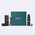 Harry's shave set with a box, razor, and other items on a white background