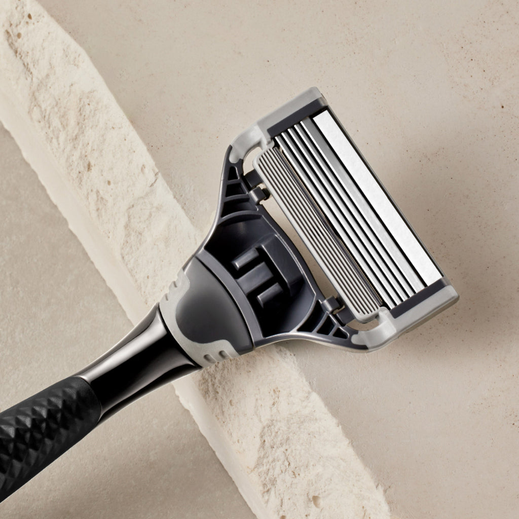 Shaving razor on a beige background