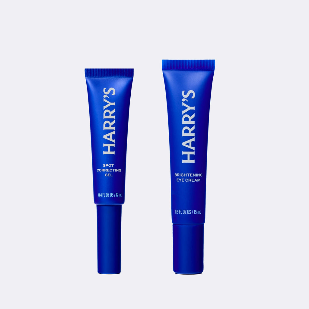 Two blue tubes of Harry's skincare products on a white background