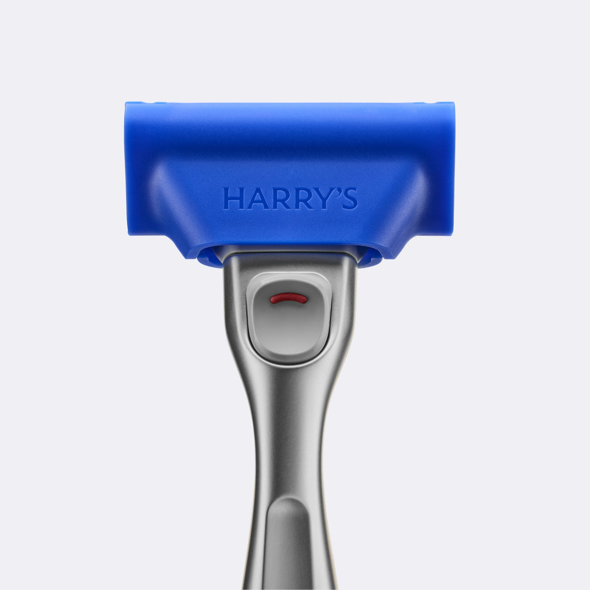Blue and silver grooming tool with 'HARRY'S' branding on a light gray background
