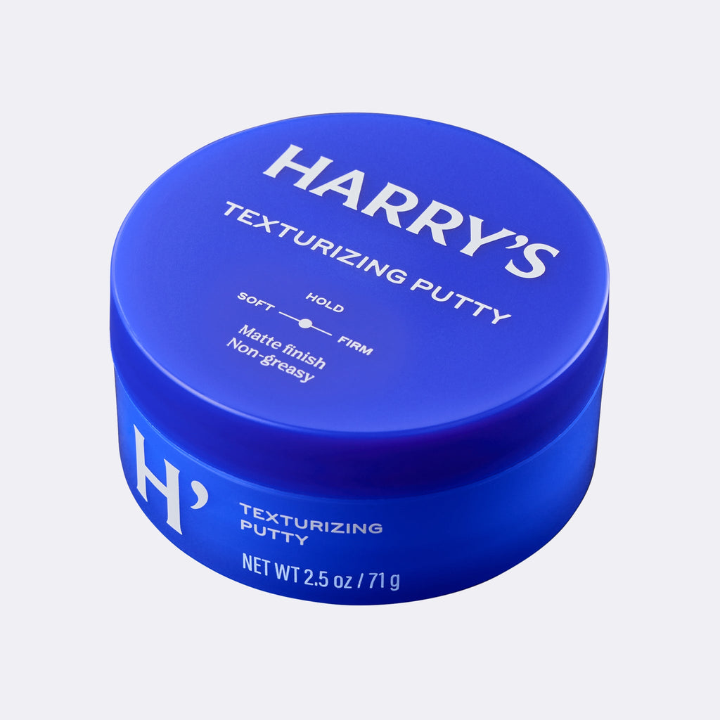 Blue jar of Harry's Texturizing Putty on a light gray background