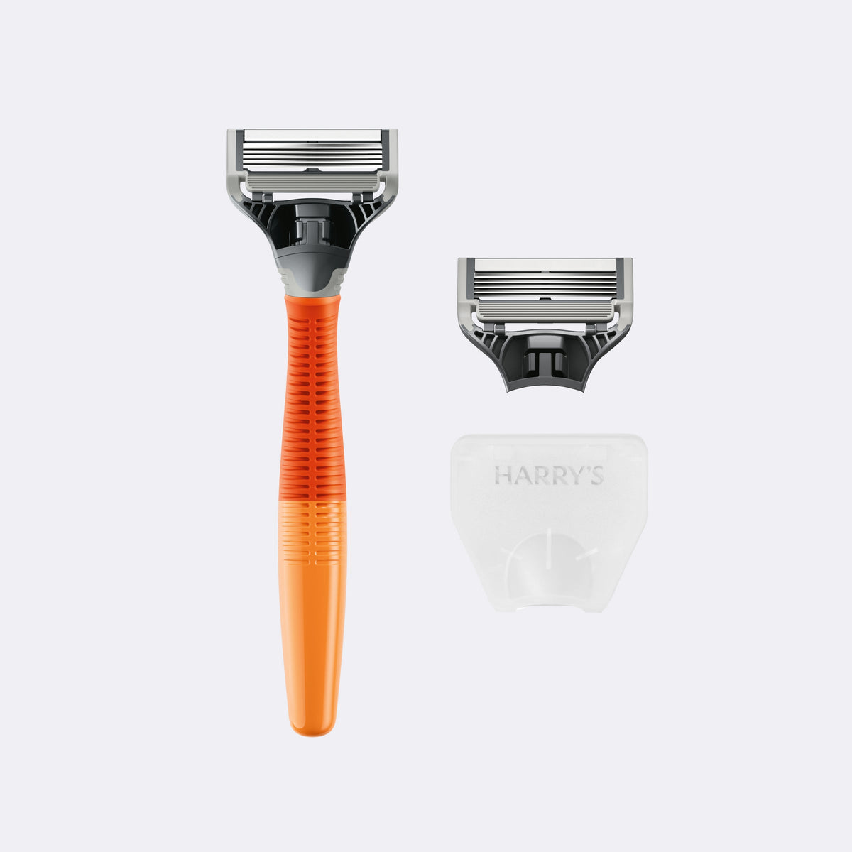 Shaving razor with orange handle and silver head, alongside a white razor head on a light gray background.