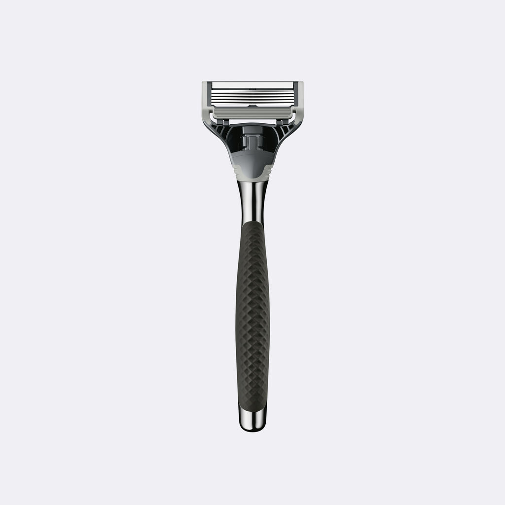 Shaving razor with black handle and silver head on a white background