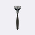 Shaving razor with black handle and silver head on a white background