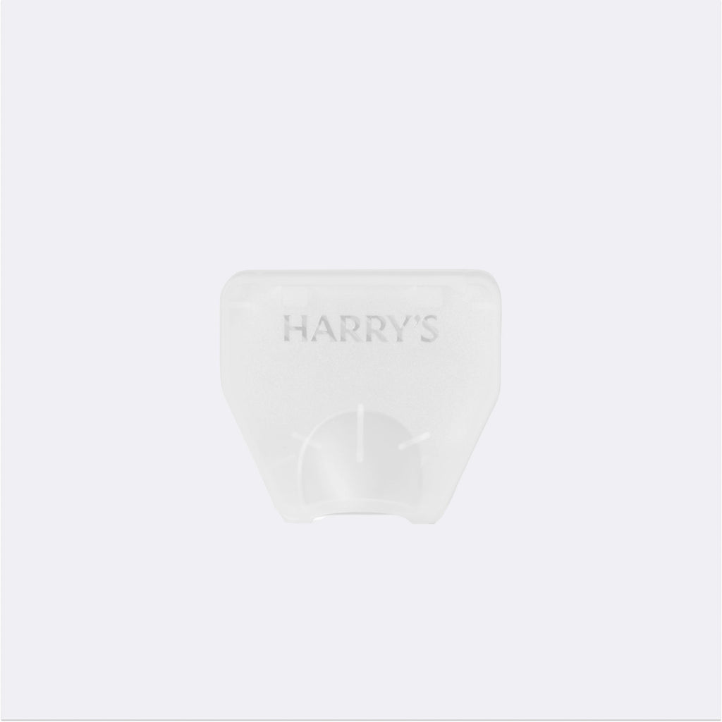 Clear plastic blade cover with 'HARRY'S' branding on a white background