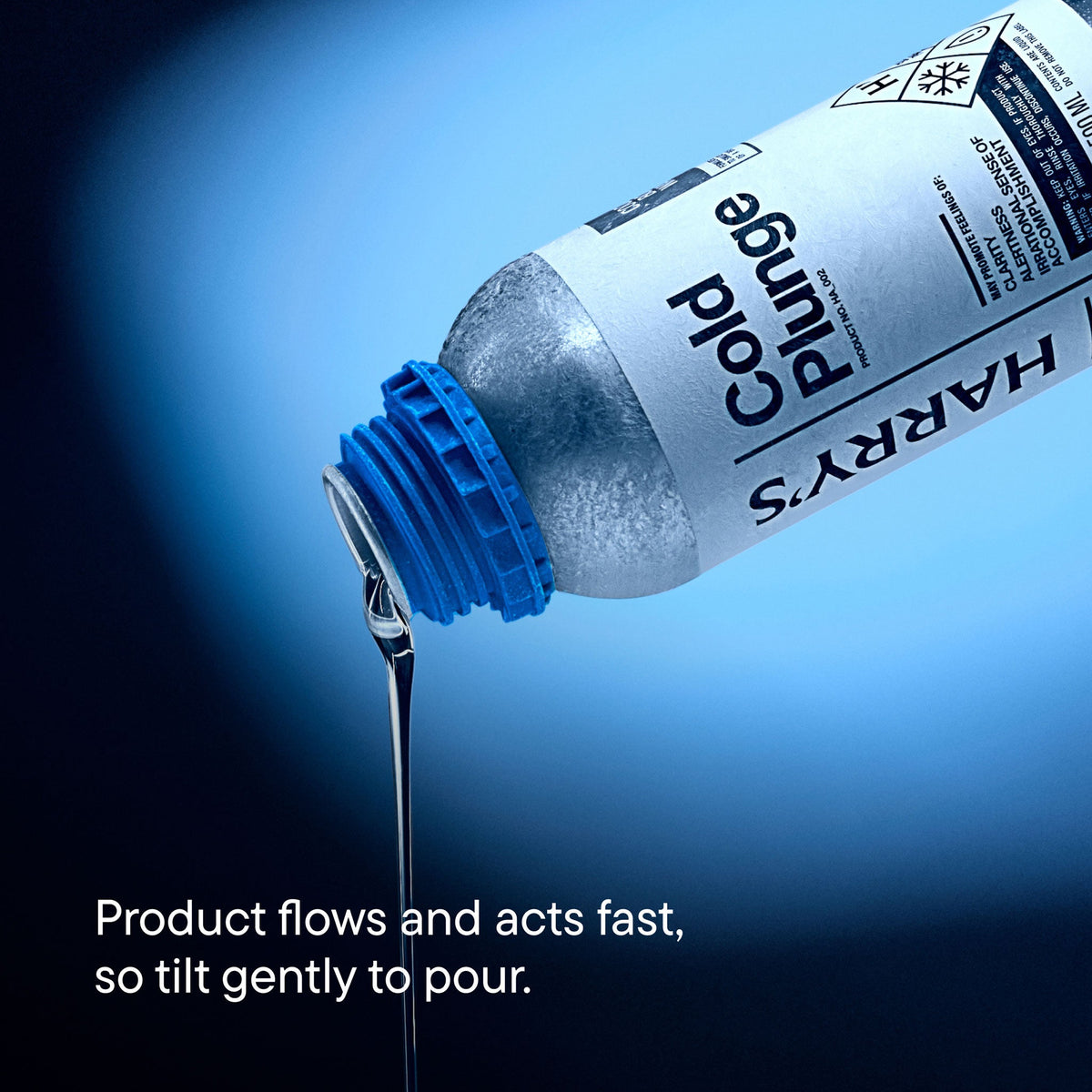 Bottle of Harry's Cold Plunge product with blue cap and flowing liquid against a blue background.