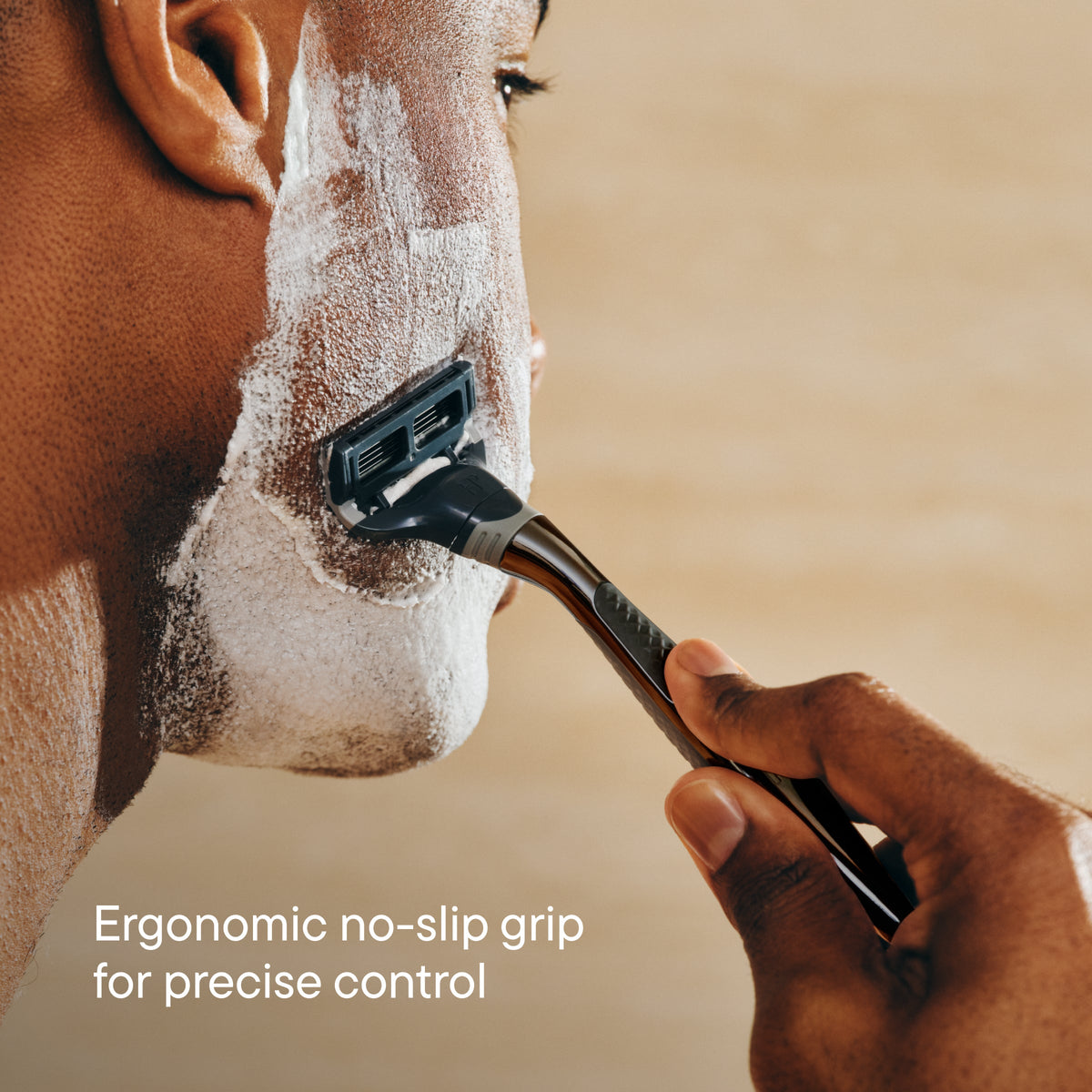 Person shaving a horse's face with a razor, emphasizing ergonomic design.