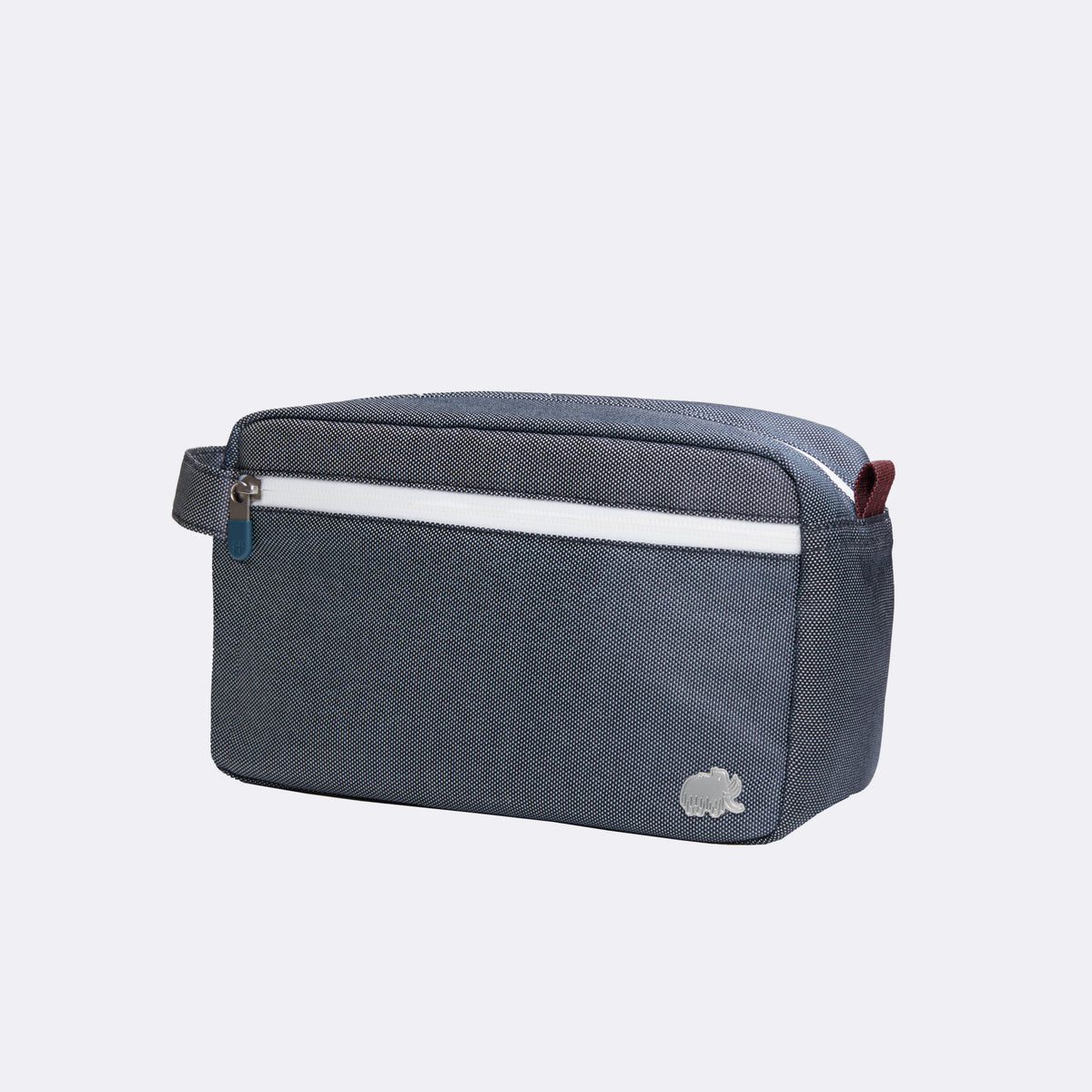 Blue toiletry bag with white stripe on a light gray background